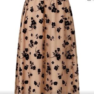 Unusual design on this medium midi skirt.Pink Mesh Overlay/Black Rose Appliques.